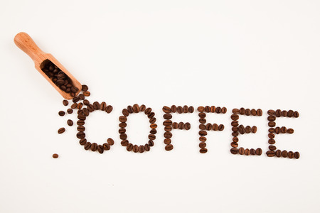coffee sign made of coffee beans on white backgroundの写真素材