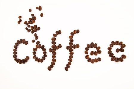 coffee sign made of coffee beans on white backgroundの写真素材