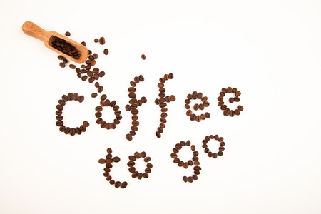coffee sign made of coffee beans on white backgroundの写真素材