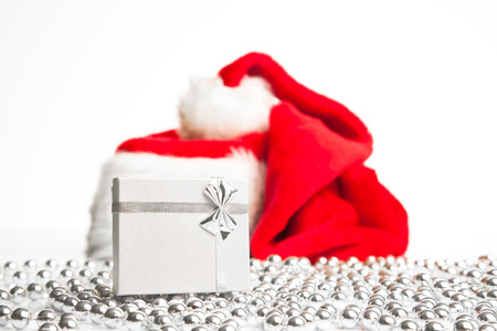 A gift box standing next to Santa Claus red hat の写真素材