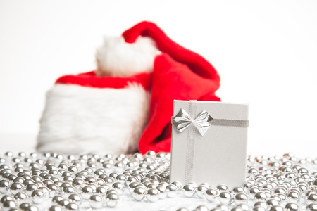 A gift box standing next to Santa Claus red hat の写真素材