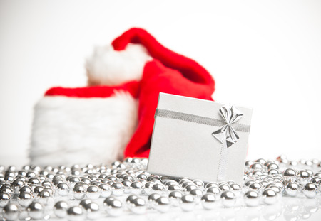 A gift box standing next to Santa Claus red hat の写真素材