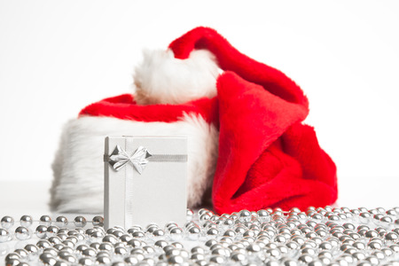 A gift box standing next to Santa Claus red hat の写真素材