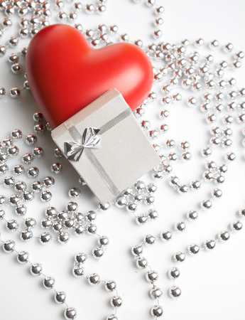 A gift box and a ceramic heart の写真素材