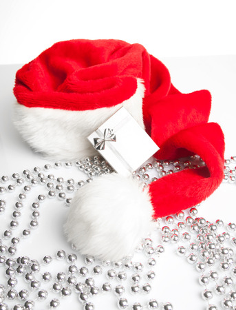 A gift box standing next to Santa Claus red hat の写真素材