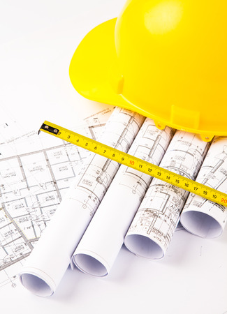 photo of hardhat and measure on blue print の写真素材