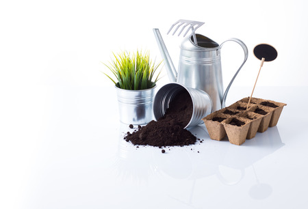 Subtle metal gardening items and flowers composition isolated on whiteの写真素材