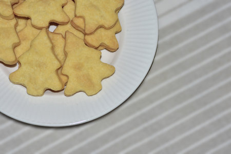 Big plate with christmas tree shape cookies. Cristmas themed baking cookies. Homemade christmas tree...
