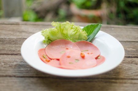 Spicy bologna on wood table.の写真素材