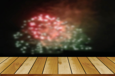 image of wooden table in front of blurred fireworks background