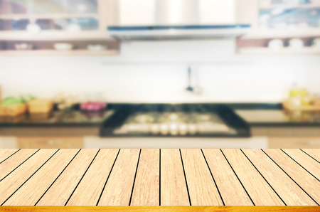 Empty wooden table and blurred kitchen background.can be used for montage or display your products.の写真素材