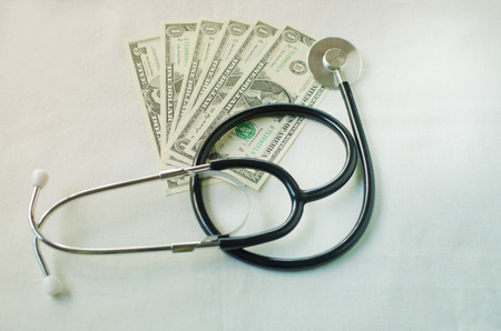 Stethoscope on money background.finance concept.の写真素材