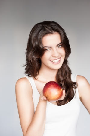 young casual caucasian girl with red appleの写真素材
