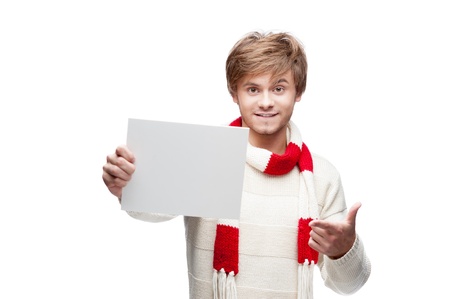 portrait of young cheerful caucasian man which pointing at sign with funny expressionの写真素材