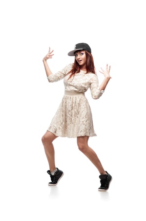 young caucasian red-haired female dancer showing move over white backgroundの写真素材