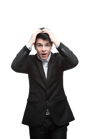 young caucasian brunette businessman put his hands on head with stressed expressionの写真素材