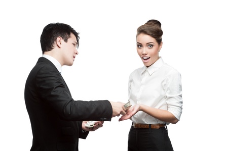 young brunette caucasian businessman giving a lot of dollars to surprised smiling business womanの写真素材