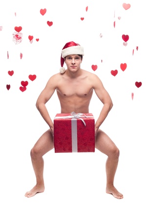 young cheerful caucasian funny man in santa hat holding christmas gift isolated on whiteの写真素材