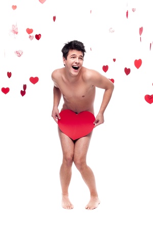 young cheerful caucasian funny  man holding cbig red paper heart isolated on white background with falling red heartsの写真素材