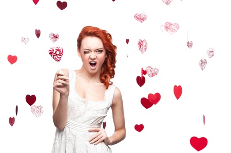 young cheerful caucasian red-haired woman holding lollipopの写真素材