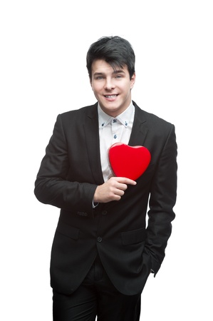 young happy business man holding red Valentine heart isolated on whiteの写真素材