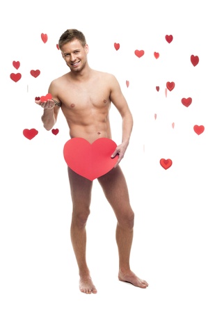 young cheerful caucasian funny naked man holding cbig red paper heart isolated on white background with falling red heartsの写真素材