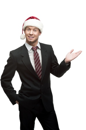 young smiling caucasian businessman in black suit and santa hat isoalted on whiteの写真素材