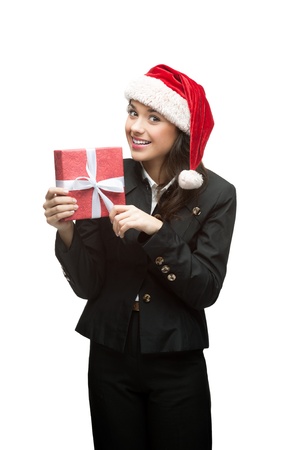 young caucasian business woman in black suit and santa hat holding red gift isoalted on whiteの写真素材