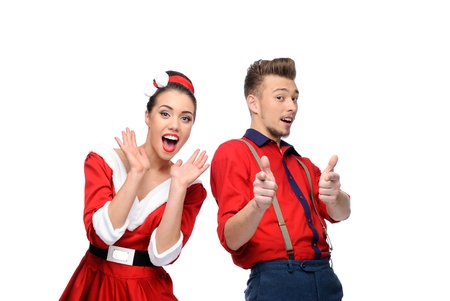 cheerful young surprised caucasian couple in red vintage clothing isolated on whiteの写真素材