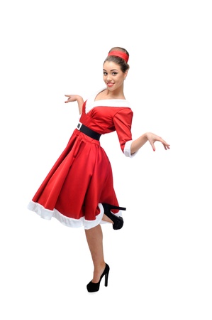 cheerful young caucasian woman in red vintage clothing dancing isolated on whiteの写真素材