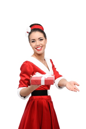 cheerful young caucasian woman in red vintage clothing holding red christmas gift isolated on whiteの写真素材