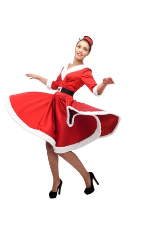 cheerful young caucasian woman in red vintage clothing dancing isolated on whiteの写真素材