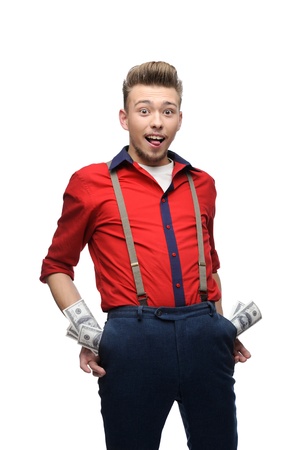 happy young caucasian man in red vintage clothing with money in his pockets isolated on whiteの写真素材