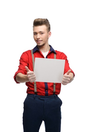 cheerful young caucasian man in red vintage clothing holding sign isolated on whiteの写真素材