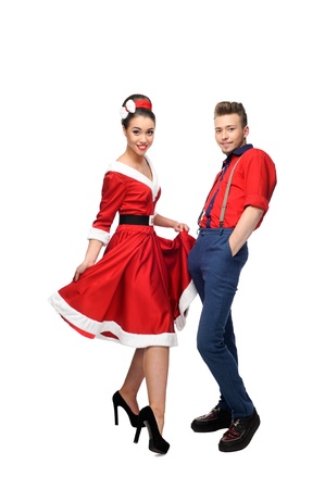 cheerful young caucasian couple in red vintage clothing standing isolated on whiteの写真素材
