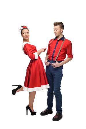 cheerful young caucasian couple in red vintage clothing standing isolated on whiteの写真素材