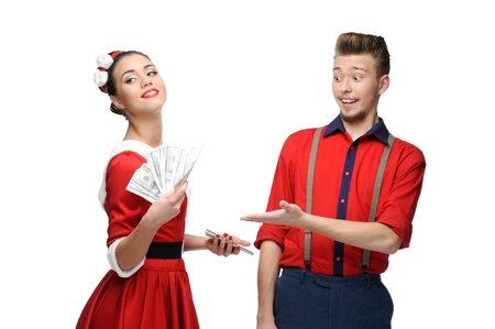 cheerful young caucasian couple in red vintage clothing holding money isolated on whiteの写真素材