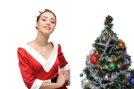 young cheerful retro girl standing near christmas tree isolated on whiteの写真素材