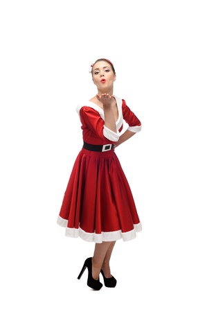 cheerful young caucasian woman in red vintage clothing giving a kiss isolated on whiteの写真素材