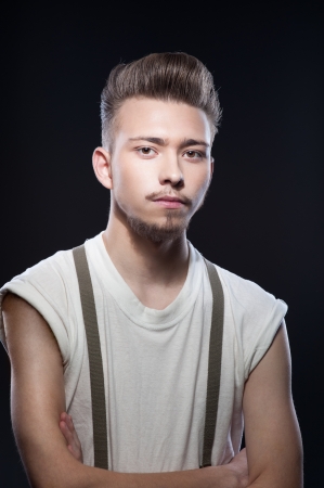 portrait of young caucasian calm retro man on gray backgroundの写真素材