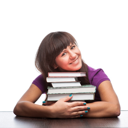 caucasian smiling girl hugging books isolated on whiteの写真素材