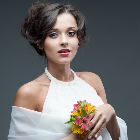 portrait of young attractive caucasian woman with lily flowersの写真素材