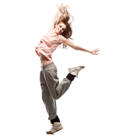 beautiful young casual caucasian  hip-hop dancing woman  over gray backgroundの写真素材
