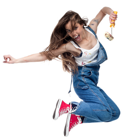 cheerful young caucasian crazy woman jumping and screaming isolated on whiteの写真素材