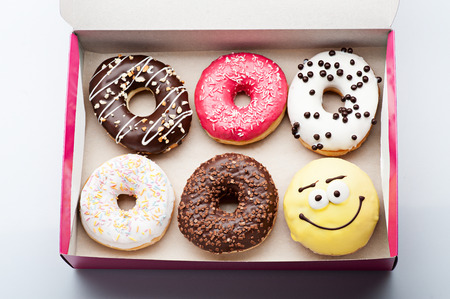 donuts set in paper box on whiteの写真素材