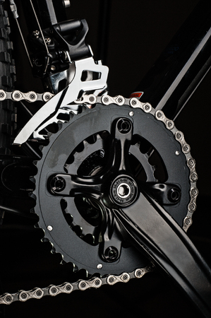 studio close-up mountain bicycle crankset on dark background