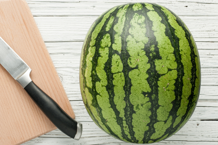 yellow ripe watermelon slices on white wooden background top viewの写真素材