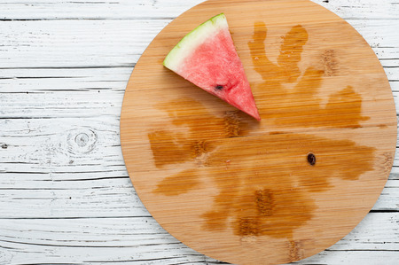 ripe watermelon slice on white wooden background top viewの写真素材