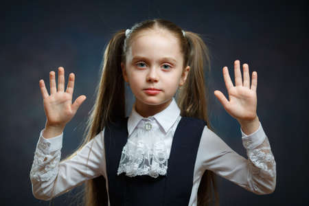 Smart Caucasian School Girl Close-up Portrait. Attractive Preteen Kid Show Both Palm. Cute Beautiful Preschool Child Look Smart Education System Concept Isolated Front Camera Face Shotの写真素材