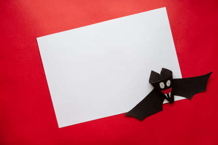 Funny Halloween Bat Made From Paper on a Red Background. Postcard on Helloween.の写真素材